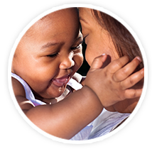 baby holding womans face